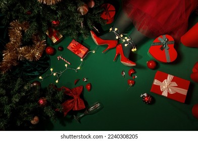 Christmas background with presents, Christmas tree and legs on green background with lights  - Shutterstock ID 2240308205