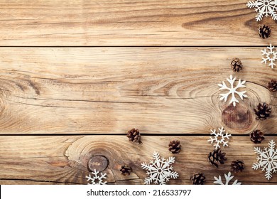 Christmas Background With Snowflakes And Cones On Wooden Table With Copy Space. Top View