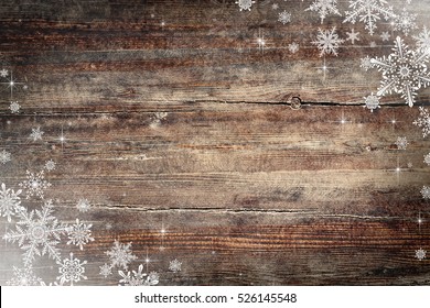 Christmas background with snowflakes on wooden texture