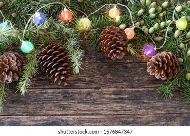 Christmas background with string lights and pine tree cone, Xmas concept on the table - Powered by Shutterstock - Get 15% off with code: PIKWIZARD15