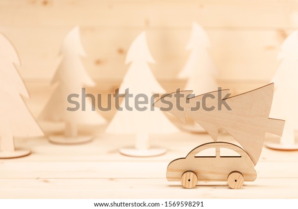 Christmas
background. Toy handmade wooden car with christmas tree. Merry
Christmas and Happy New Year
background