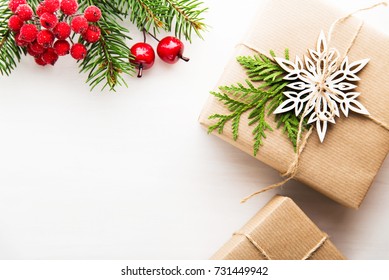 Christmas Background With Xmas Tree, Gift Boxes And Red Berries On White Wooden Background. Merry Christmas Greeting Card, Frame, Banner. Winter Holiday Theme. Happy New Year. Space For Text. 