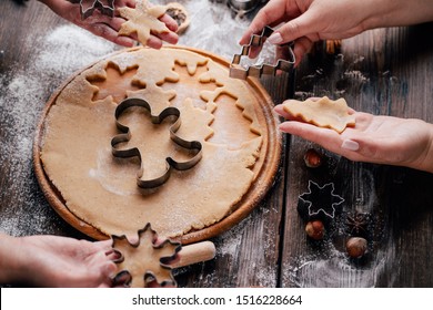 Christmas bakery. Friends making gingerbread, cutting cookies of gingerbread dough, view from above. Festive food, cooking process, family culinary, Christmas and New Year traditions concept - Powered by Shutterstock