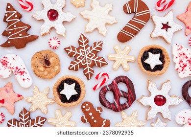 Christmas baking background with an assortment of cookies and sweet treats. Top down view on a white marble background. Holiday baking concept. - Powered by Shutterstock