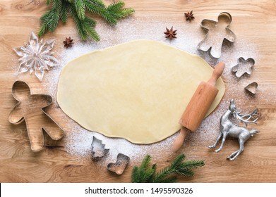 Christmas baking background with copy space for a greeting text, peace of dough rolled out for cooking Xmas gingerbreads, top down view - Powered by Shutterstock