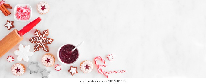 Christmas baking corner border with cookies and sweets. Top view over a white marble background with copy space. Holiday baking concept. - Powered by Shutterstock