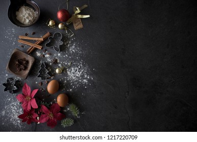 Christmas Baking Ingredients On Black Table, Christmas Flatlay On Dark Background With Copy Space. Christmas Cake Ingredients Top Down Shot