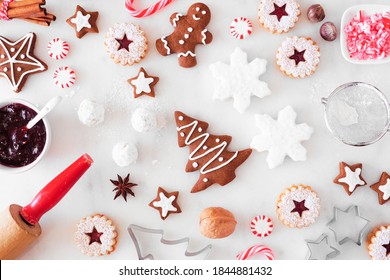 Christmas Baking Table Scene With Cookies And Sweets. Top Down View Over A White Marble Background. Holiday Baking Concept.