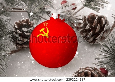 Christmas ball with the flag of Soviet Union, decorates the snow tree with snowfall. The concept of the Christmas and New Year holiday