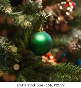 Christmas ball on a green Christmas tree. Close up.