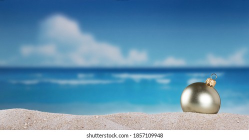 Christmas Ball In The Sand On The Beach On A Bright Sunny Day Of New Years Eve