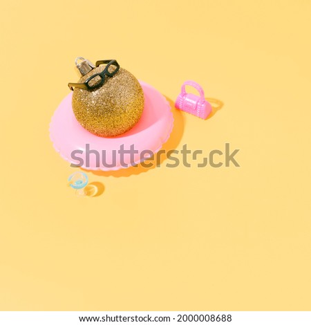 A christmas ball sunbathing on a float. concept of summer, travel and christmas. 3d illustration. copy space