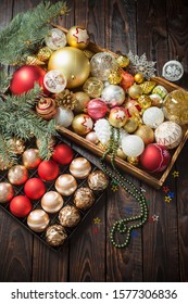 Christmas balls in box on dark wooden background