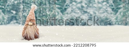 Christmas banner with cute gnome in snowy winter forest, copy space. Fairytale snowfall