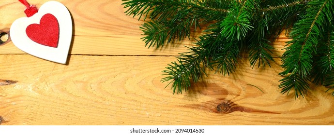 Christmas banner with fir tree branch and decorations on wooden background