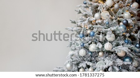 Christmas banner with Christmas tree with silver and blue decorations and lights. Christmas tree on a white background with copy space, place for text
