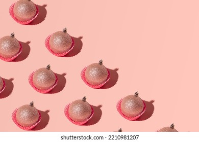 Christmas Baubles In Cupcake Liners, Creative Pattern On Pastel Pink Background. 