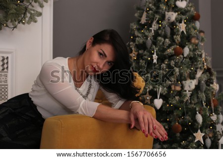Christmas beauty smiling girl with long black hair in a good mood