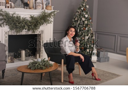 Christmas beauty smiling girl with long black hair in a good mood