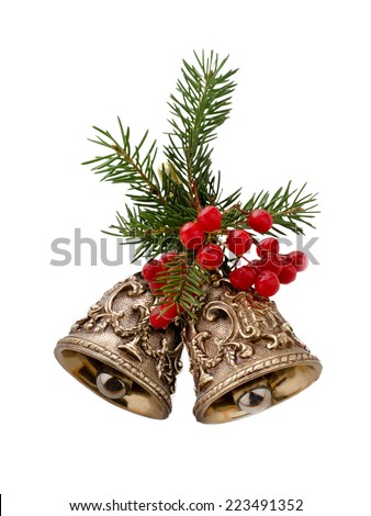 Christmas bells decorated with fir branches and berries isolated on a white background