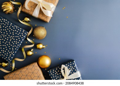 Christmas blue background with gift boxes, gold baubles, ribbon.  Flat lay, top view, copy space. Merry Christmas and Happy New Year greeting card design. - Powered by Shutterstock