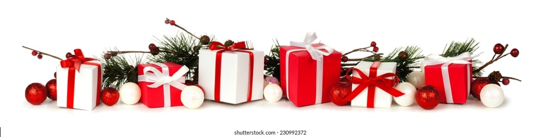 Christmas Border Of Branches And Red And White Gifts Over A White Background