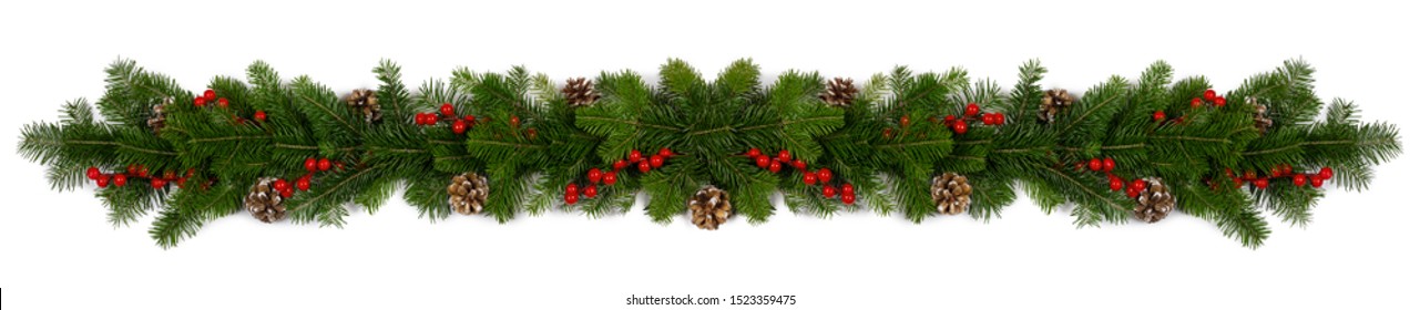 Christmas Border frame of tree branches red berries and pine cones on white background with copy space isolated - Shutterstock ID 1523359475
