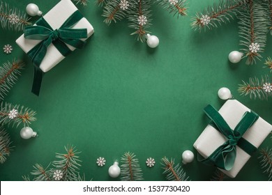 Christmas border with xmas tree and gifts on green background. Winter holiday. Happy New Year. Space for text. View from above, flat lay. Xmas. Template, mockup. Greeting card.
