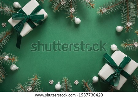 Christmas border with xmas tree and gifts on green background. Winter holiday. Happy New Year. Space for text. View from above, flat lay. Xmas. Template, mockup. Greeting card.