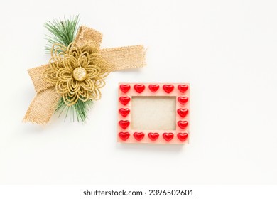 Christmas bow made of jute fabric on white surface empty frame with heart christmas concept - Shutterstock ID 2396502601