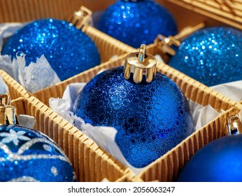 A Christmas Box With Blue Christmas Balls And Gifts, Christmas Trinkets. Preparing For The Holiday