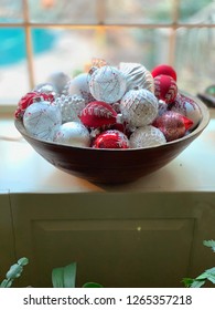 Christmas Bulbs In Old Wooden Bowl. Red And White Holiday Decorations. Old Fashioned Glass Bulbs Xmas Decor.