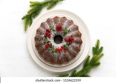 Christmas Bundt Cake Served On White Wooden Table And Decorated With Fresh Cranberries, Christmas Baking Concept Or Idea, Overhead View