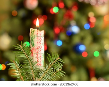 Christmas Burning Candle With Countdown Calender Date Closed Up On Blurred Green Bacground.