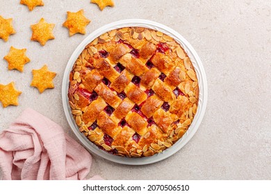 Christmas cake and cookies. Cake with cranberry jam and almonds, lattice design on top. Homemade. Top view. - Powered by Shutterstock