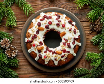 Christmas Cake With Fruits And Nuts On Wooden Table, Top View