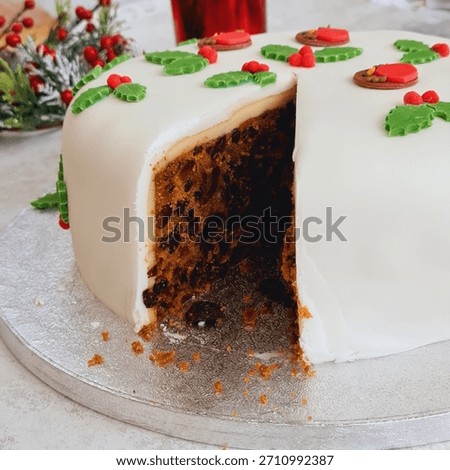 Christmas cake with a large slice missing showing the deliciously moist fruit cake inside