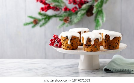 Christmas Cakes, Puddings On Cake Stand. Grey Background. Close Up. Copy Space.