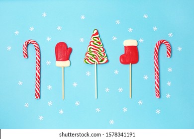 Christmas candies and little white snowflake on blue background. candy shapes, candy cane. Flat lay, top view. Copy space - Powered by Shutterstock