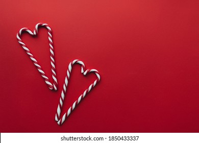 Christmas candies on red background, red white lollipop