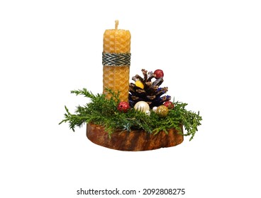 A Christmas candle in the exposition with a pine cone and juniper twigs on a cherry cut. PNG. Everything is decorated with sequins, beads. A bright beautiful photo for the background, for a postcard. 