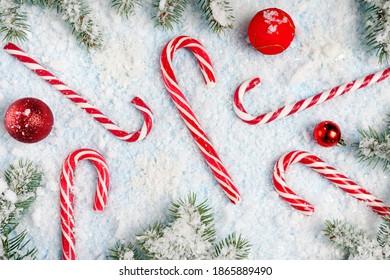 christmas candy canes with toys on white snow background, flat lay, top view - Powered by Shutterstock