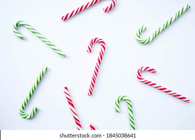 Christmas candy lollipop pattern isolated on white background. Flat lay, top view, copy space. Christmas, winter, new year concept. Christmas composition for design.