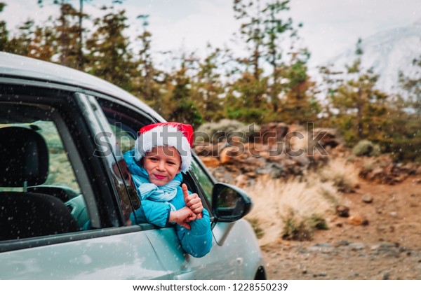 christmas\
car travel- happy kid loves travel in\
winter