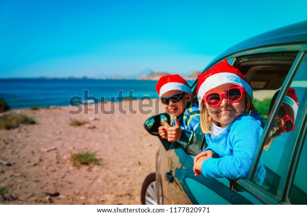 christmas car travel- happy kids travel in winter\
on beach