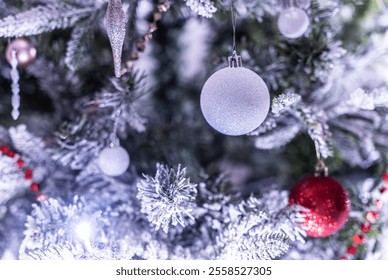 Christmas card: close-up of a Christmas tree with decorations - balls covered with sequins, glowing light bulbs, icicles, Christmas needles covered with artificial frost. - Powered by Shutterstock