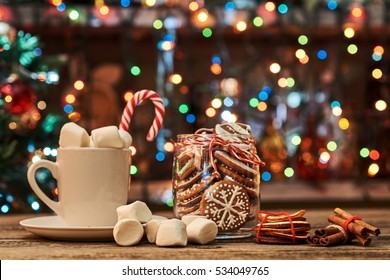 Christmas card composition with cacao, marshmallows, cinnamon, gingerbread, Christmas tree on dark wooden background. - Powered by Shutterstock