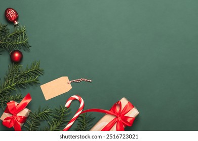 Christmas card, frame, background with pine branches and paper gift boxes, red Christmas candy cane and glass Christmas tree decorations. DIY gifts. - Powered by Shutterstock