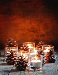 Christmas card with glowing candle featuring pine, bokeh, and closeup ...