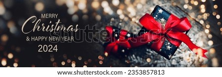 Christmas Card - Merry Christmas and Happy New Year 2024 - Beautiful gift box and golden bokeh lights